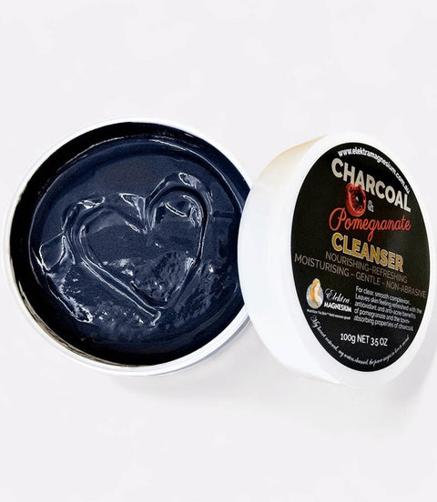 Black facial cleanser in a container with a label on a white background
