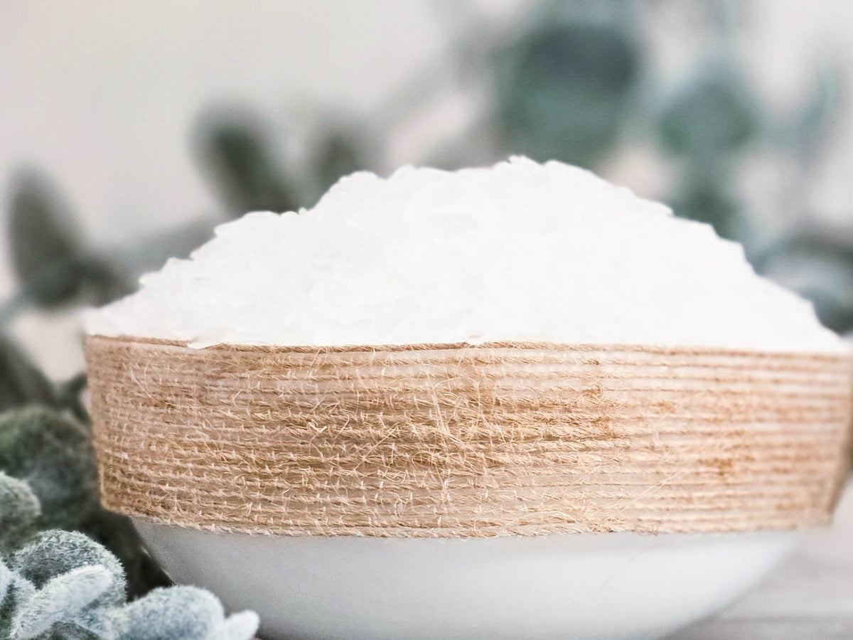Bowl of white magnesium flakes on a surface with blurred background
